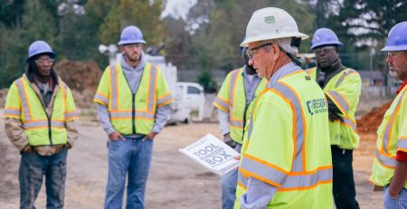 Workers wearing hard hats to avoid hazards in construction