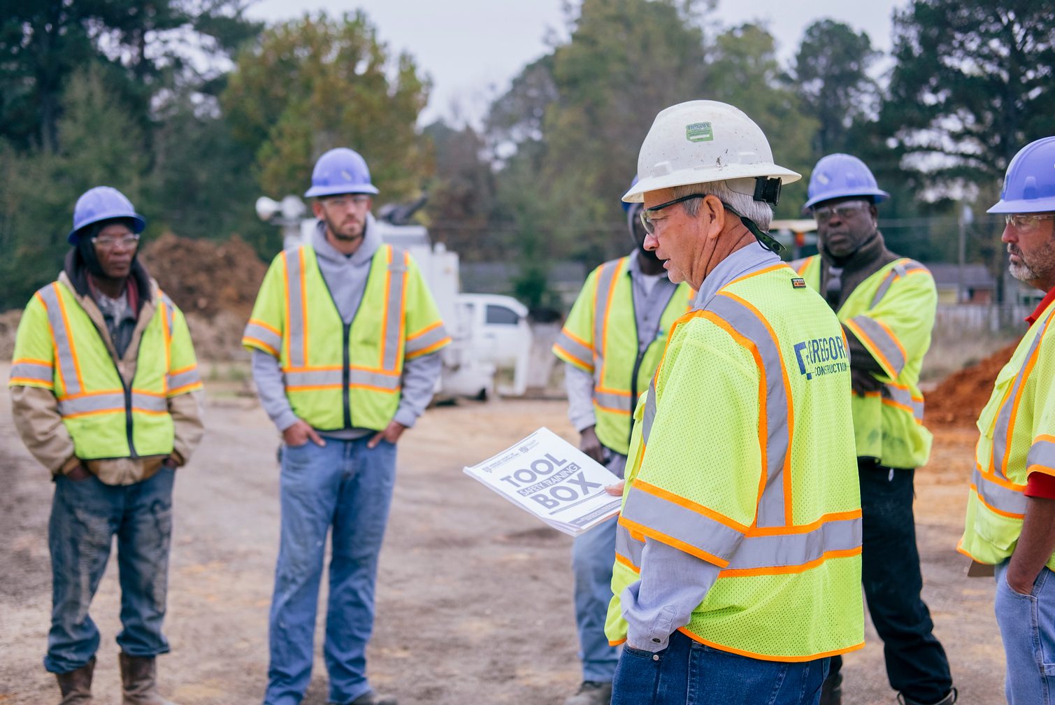 Workers wearing hard hats to avoid hazards in construction